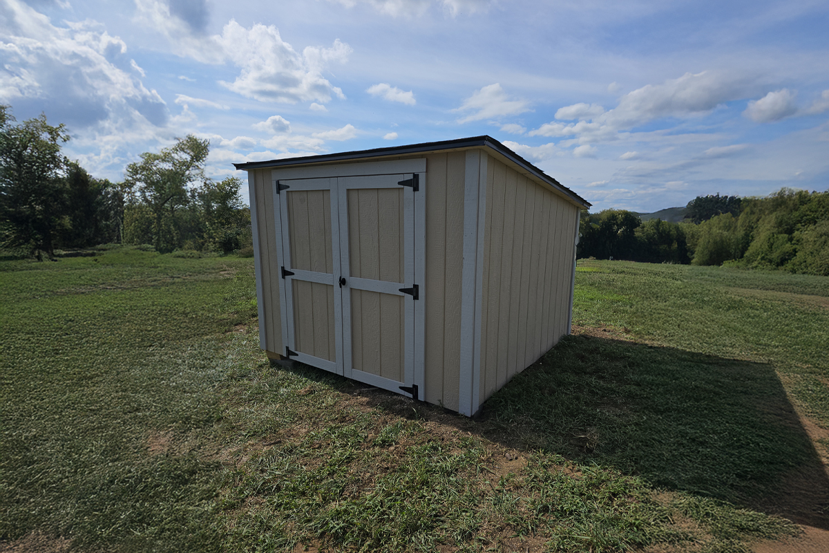 Custom studio with Hardie siding, sliding bard door, and transom windows